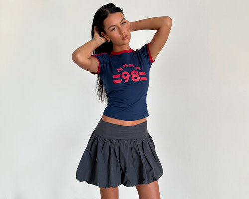 Salda Tee in Navy with Adrenaline Red Binding and '98' Emb and Kiyowo Puffball Mini Skirt In Charcoal Grey