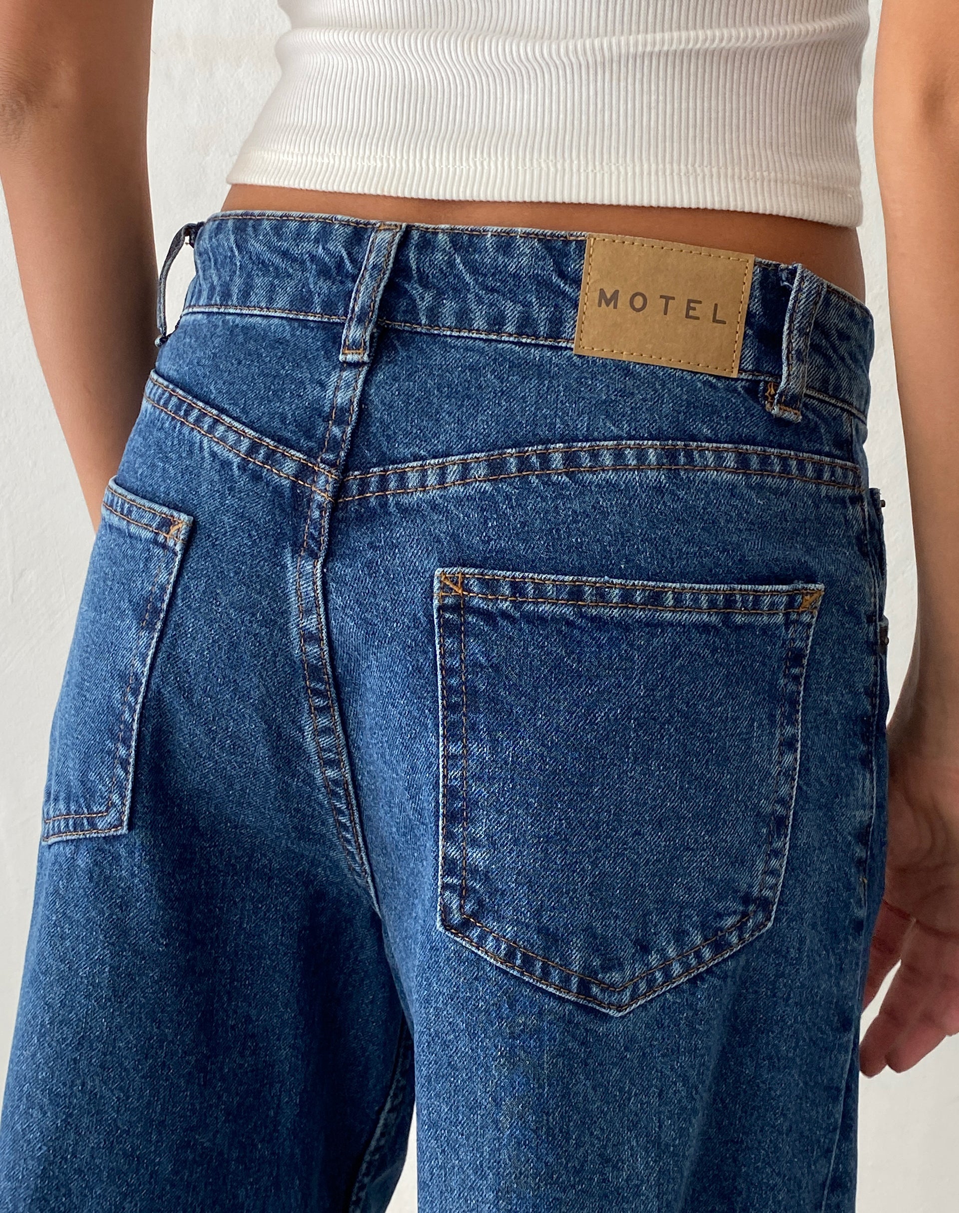 https://au.motelrocks.com/cdn/shop/files/AUS-TOP-RIB-WHITE-_-CUT-OUT-ROOMY-EXTRA-WIDE-JEANS-IN-MID-BLUE-USED-LONGER-LENGHT-0055.jpg?crop=center&height=2428&v=1689325353&width=1920