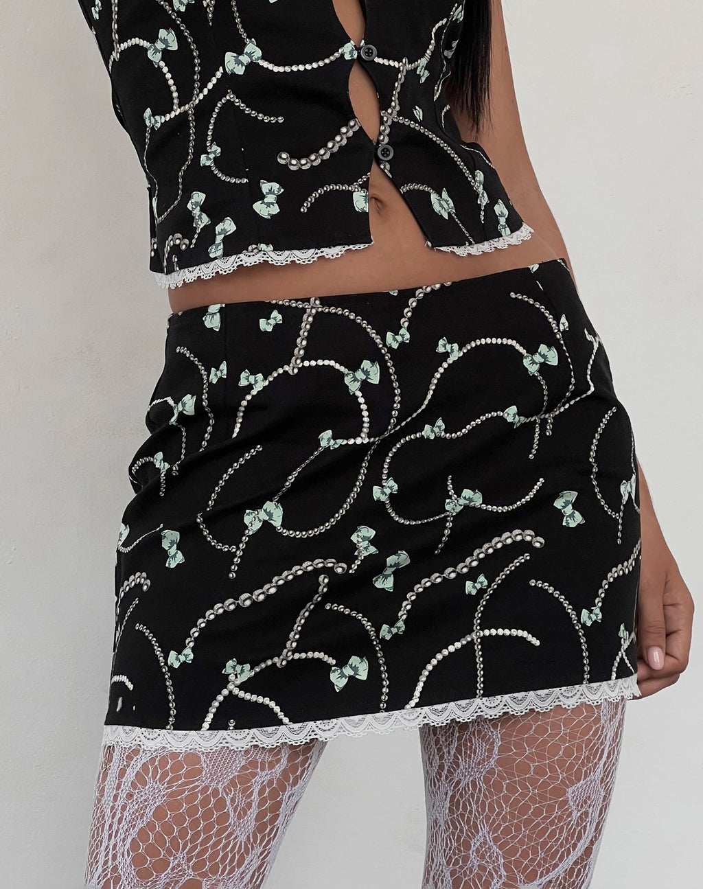Molen Mini Skirt in Black with Pearl and Bow Print